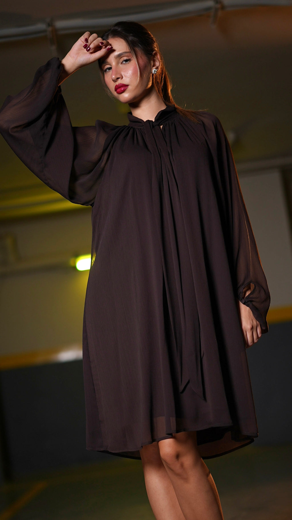 Dark chocolate-brown dress with pleated front, fluid silhouette and transparent long sleeves