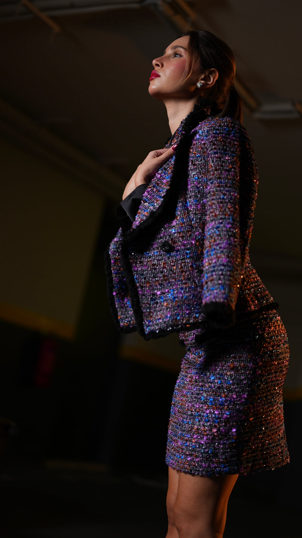 The tweed fabric is a vibrant, multicolored bouclé texture with purple, blue, pink, and gold threads,