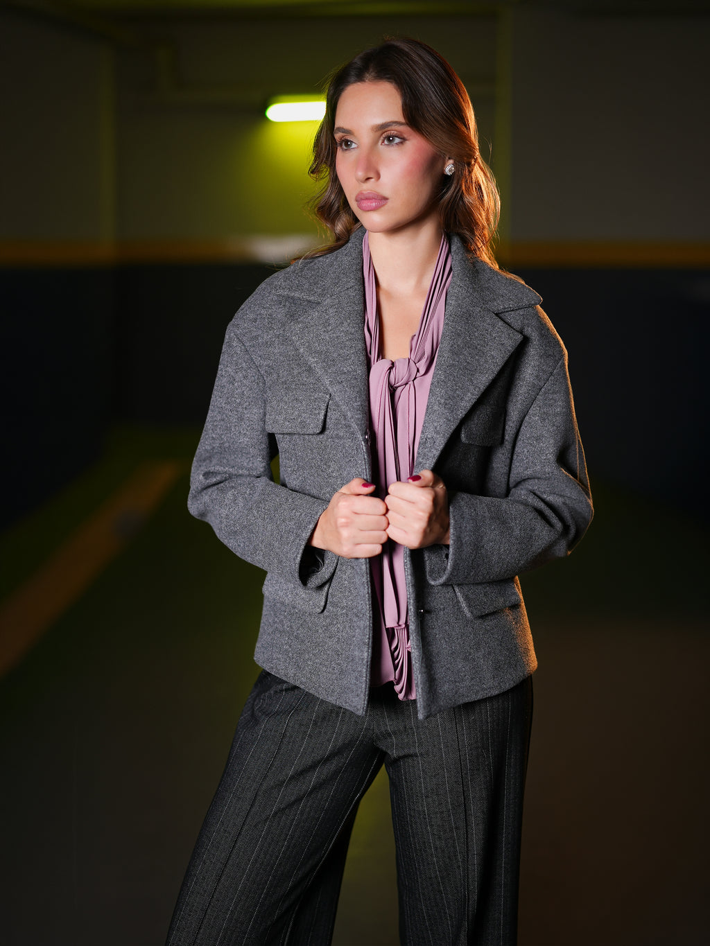 Grey wool cropped jacket worn open over a mauve blouse, front view