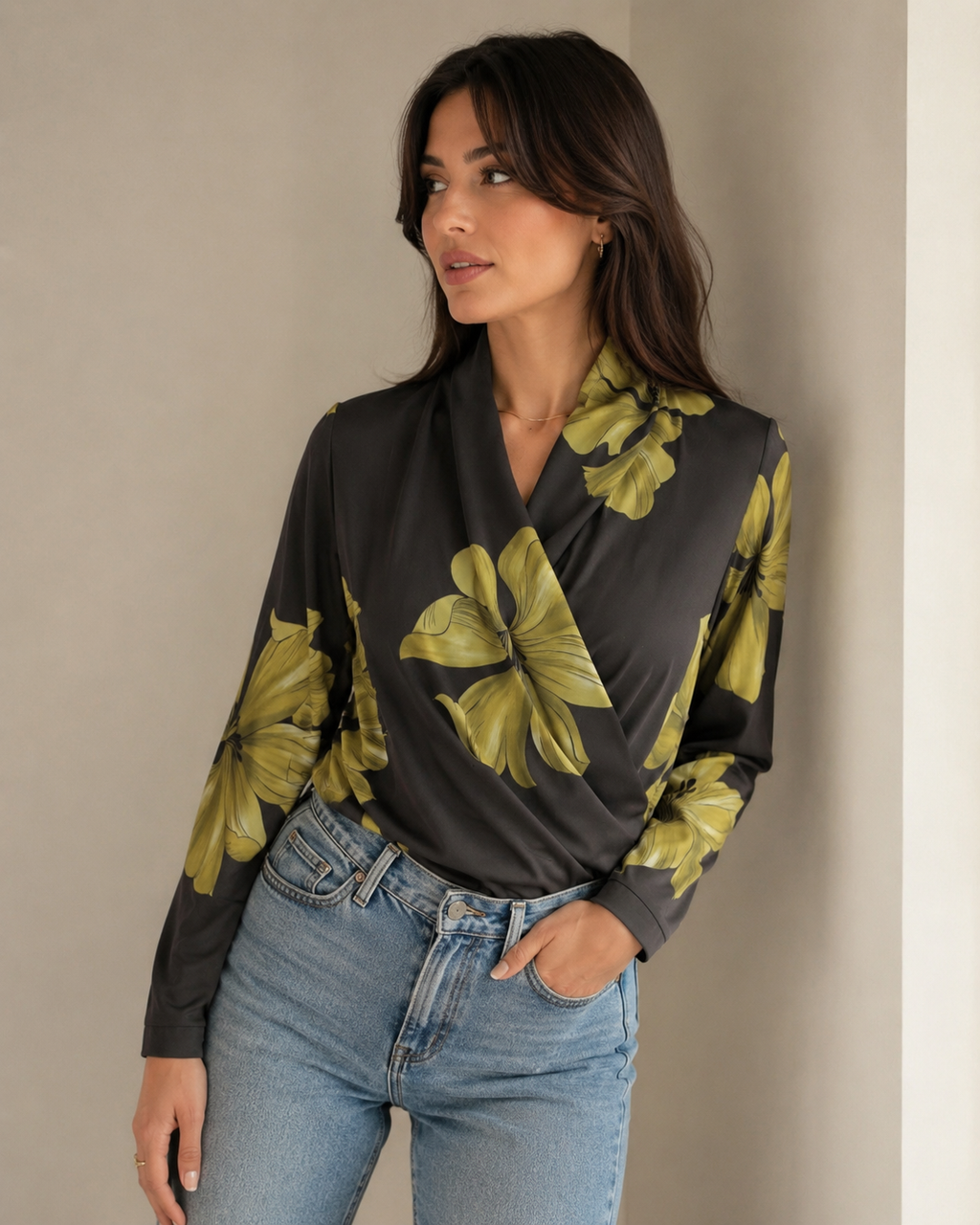 Black floral wrap blouse with V-neck and long sleeves, worn with blue jeans