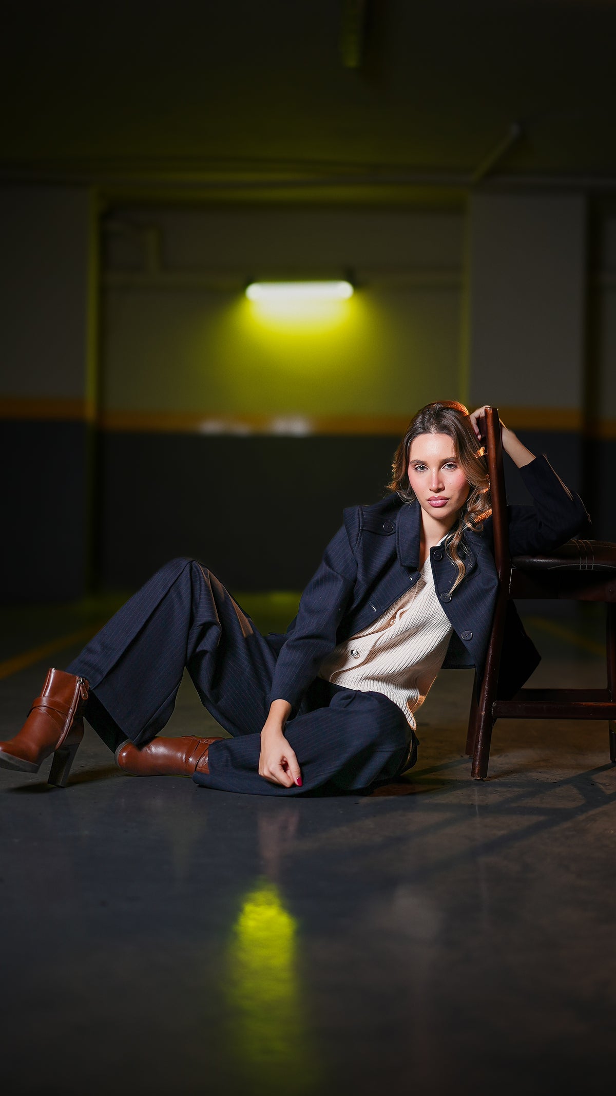 Dark navy tailored suit set with blazer and trousers, lying pose on floor