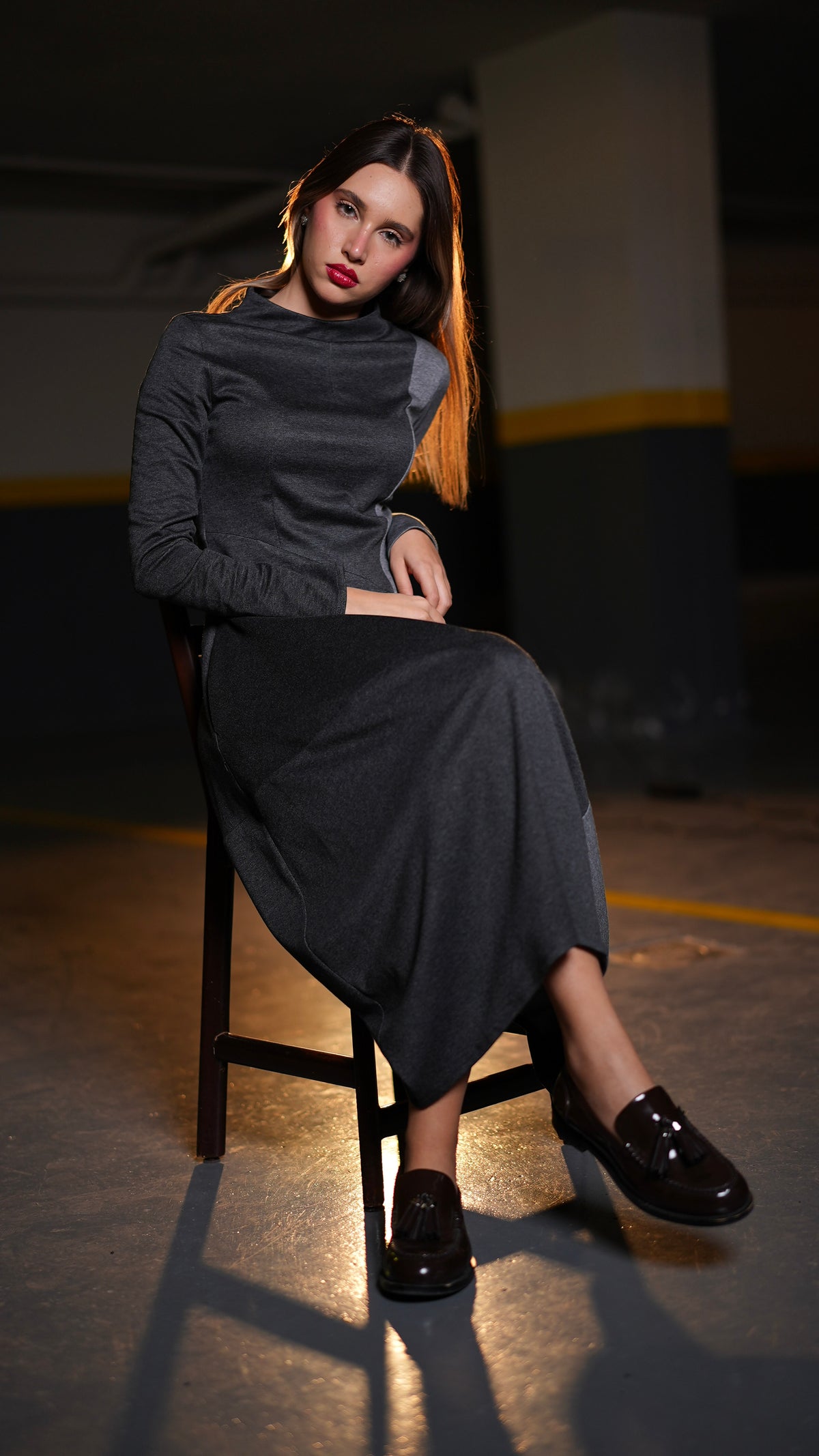 Duo Grey Dress in fluid Punto Milano with contrasting grey panels, shown on a seated model.