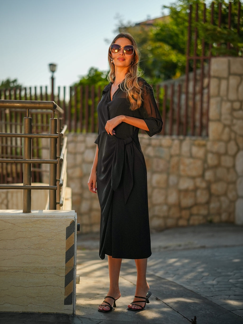 Model wearing the sheer Dramatic Dress layered over a slip, front view