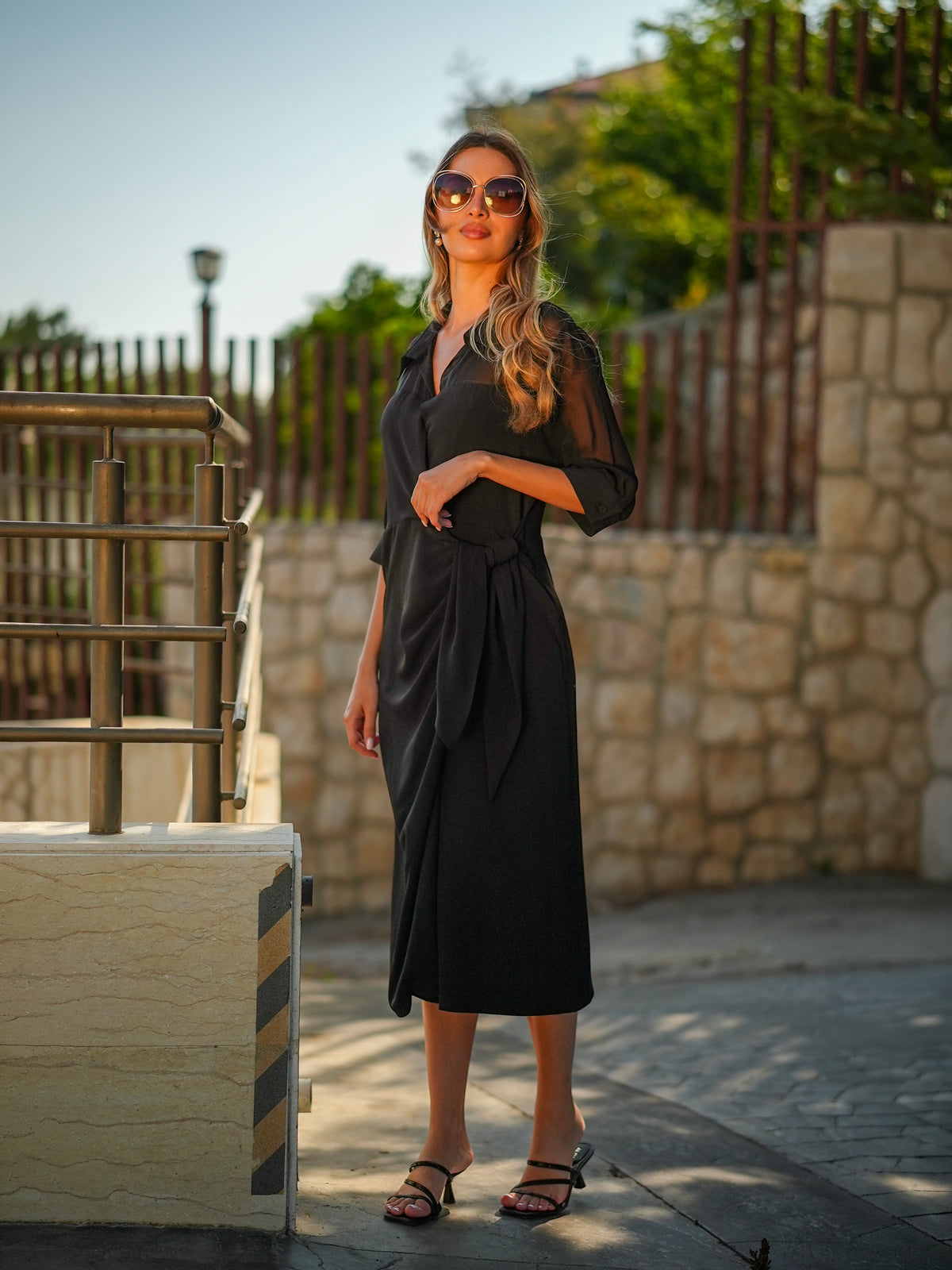 Model wearing the sheer Dramatic Dress layered over a slip, front view