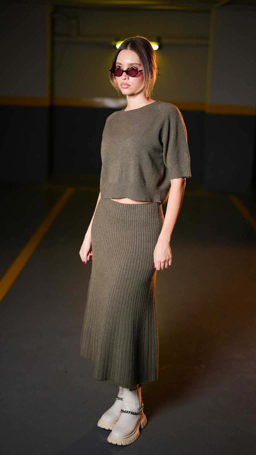 Full-length view of dark olive cropped top and midi skirt set