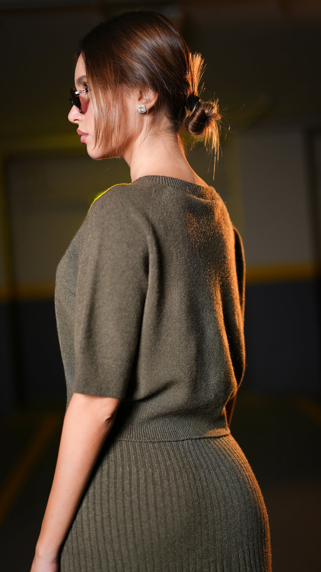 Side view of dark olive short-sleeve top and ribbed midi skirt