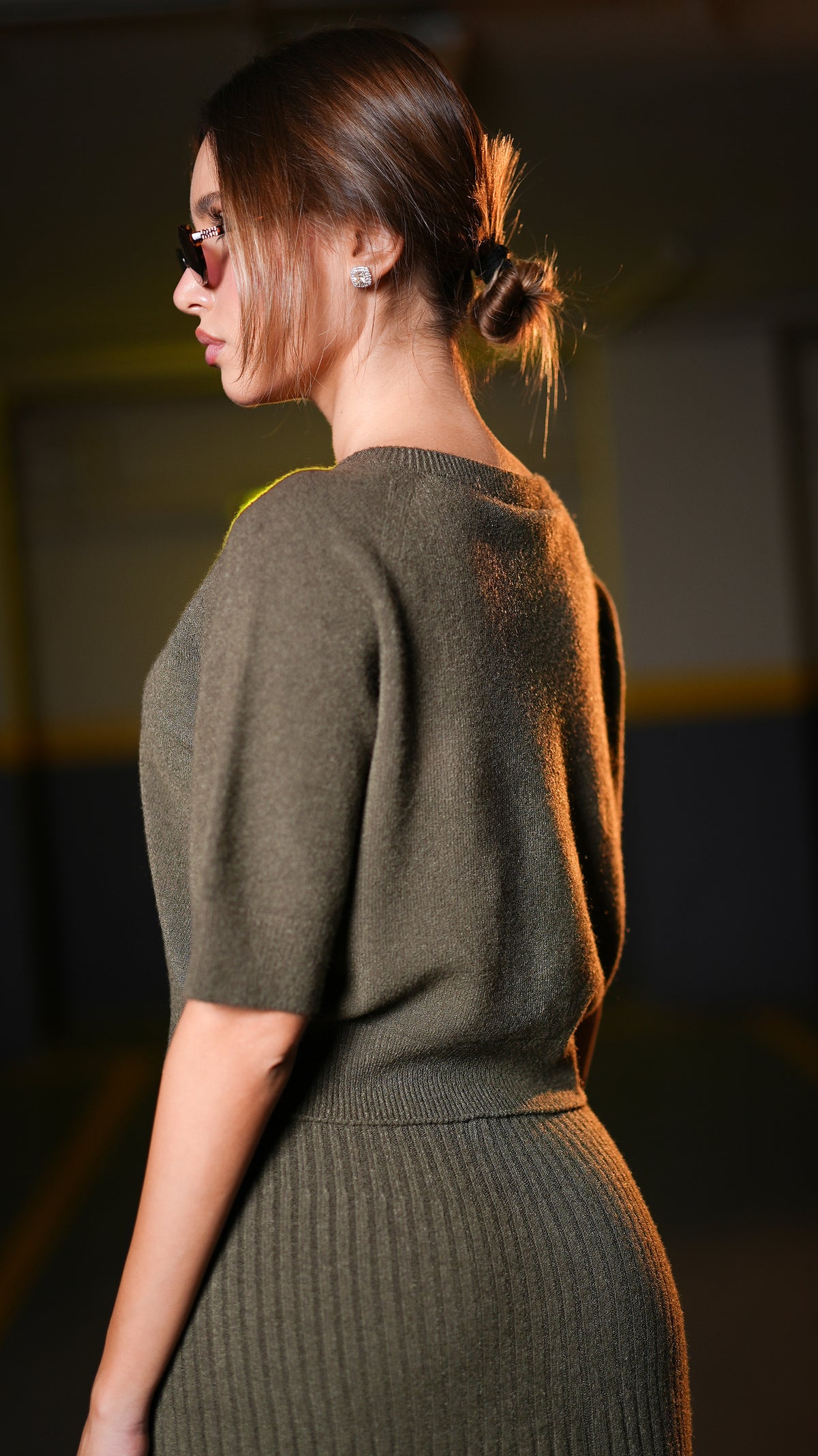 Side view of dark olive short-sleeve top and ribbed midi skirt